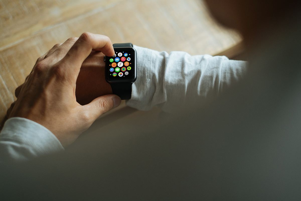 person holding Apple Watch with black Sport Band